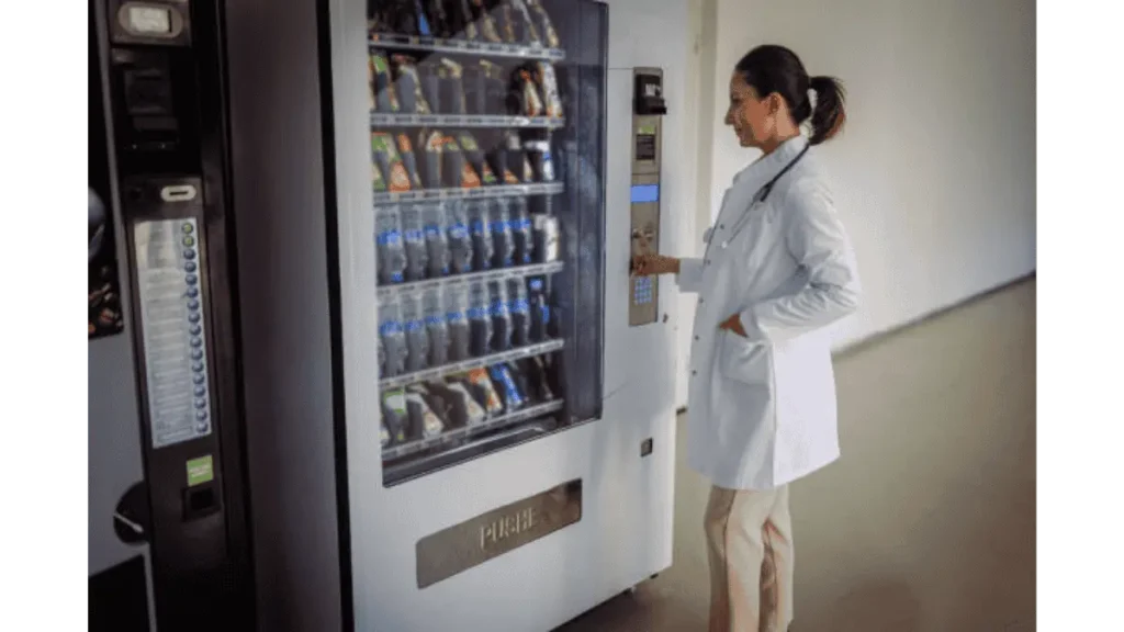 Doctor purchasing snacks and drinks from a vending machine in hospital
