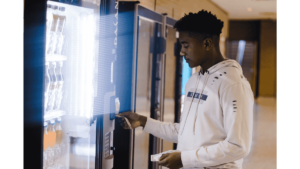 Employee buying snacks from an office vending machine
