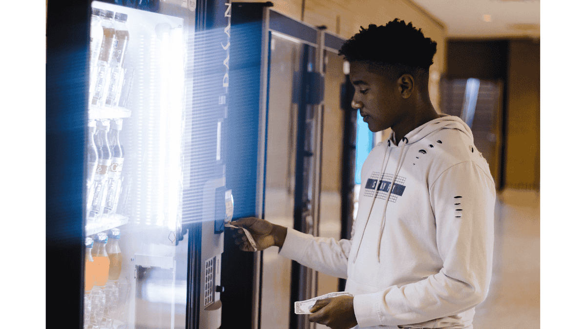 Employee buying snacks from an office vending machine