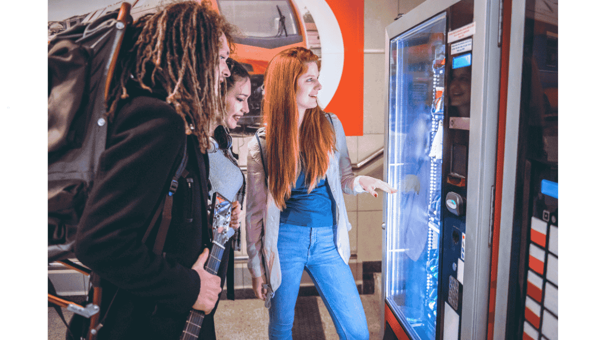 Employees selecting healthy snacks from a smart vending machine in a Malaysian office