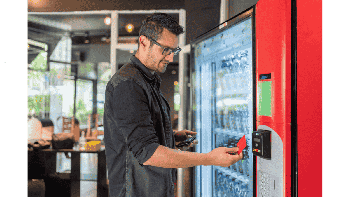 Employees using an office vending machine in Malaysia for snacks and essentials