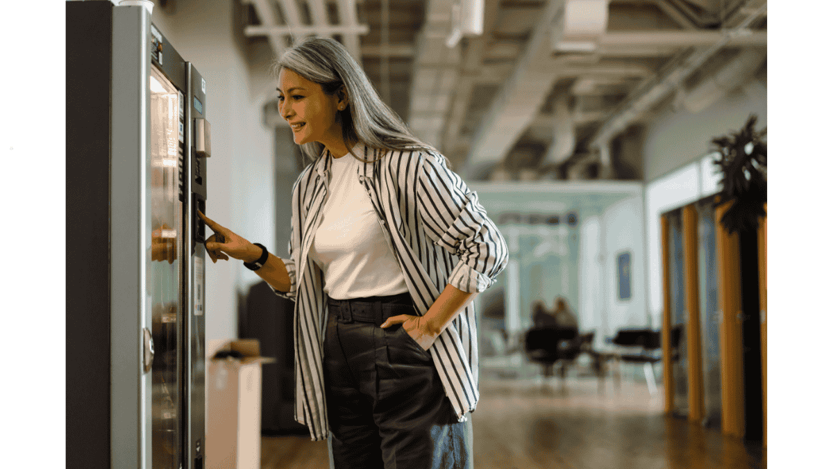 Employees using an office vending machine in Malaysia