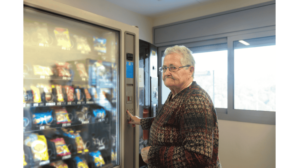 Staff selecting items from a modern office vending machine