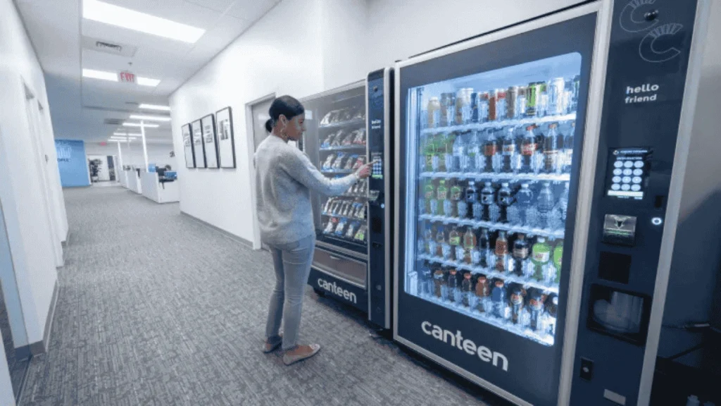 Office staff buying drinks from a vending machine