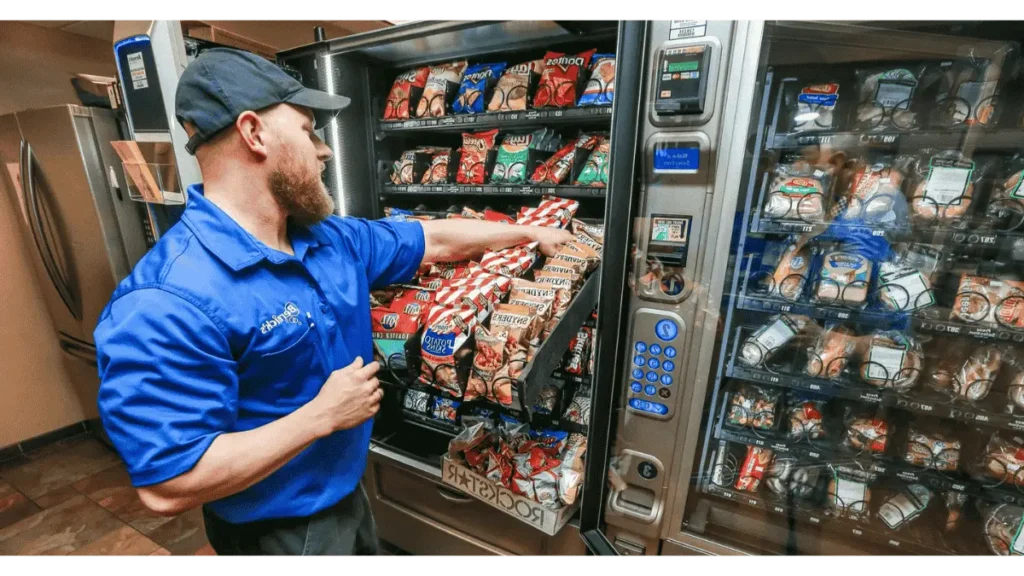 vending machine operator replenishing product into vending machine